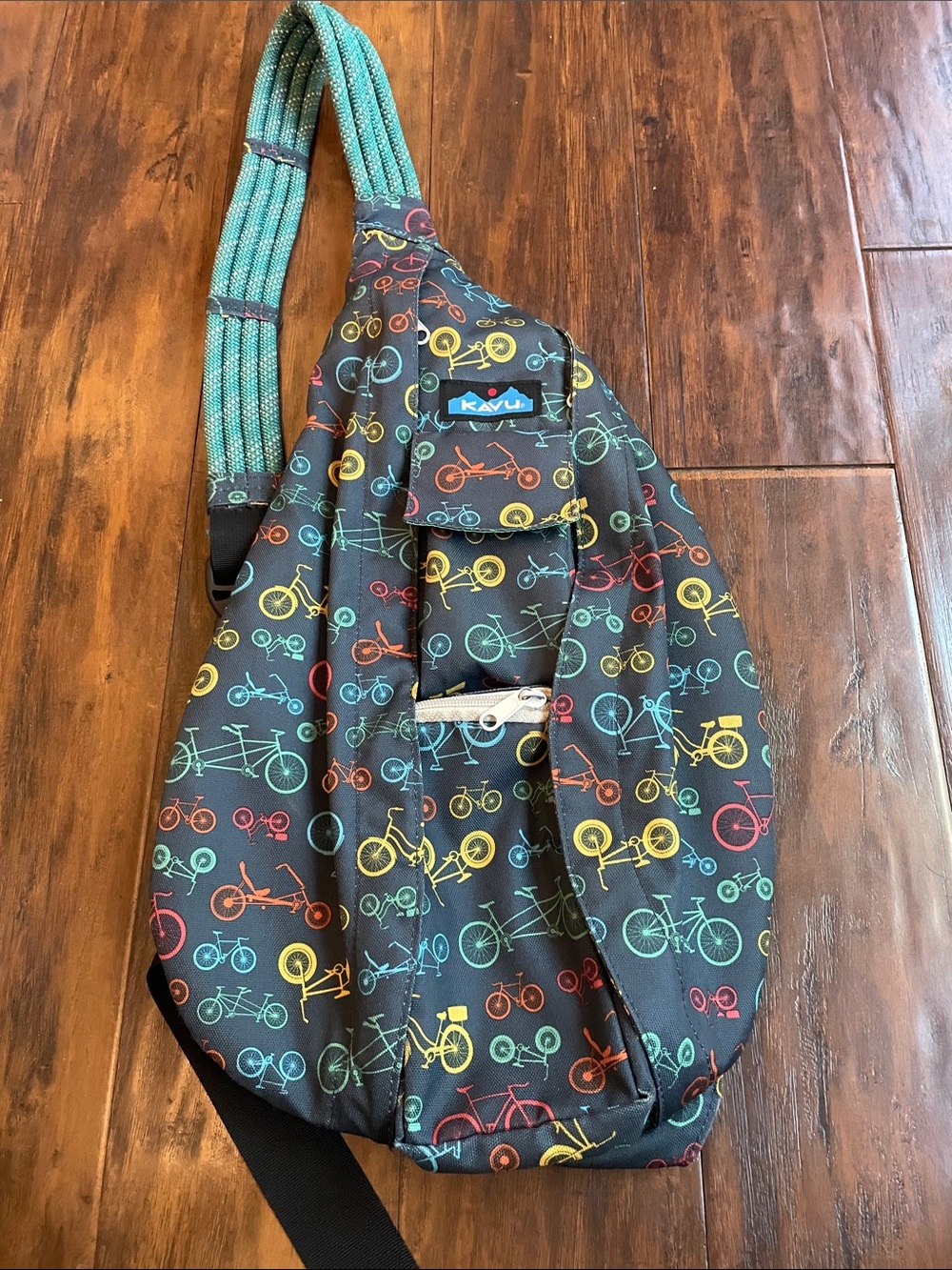 Kavu Black Sling Bag with Teal, Yellow, Red & Orange Bicycle Print